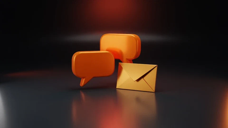 Orange speech bubbles and an amber envelope on a dark surface